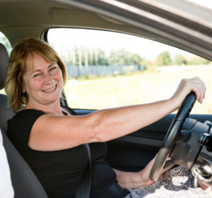Mature woman with daughter driving car